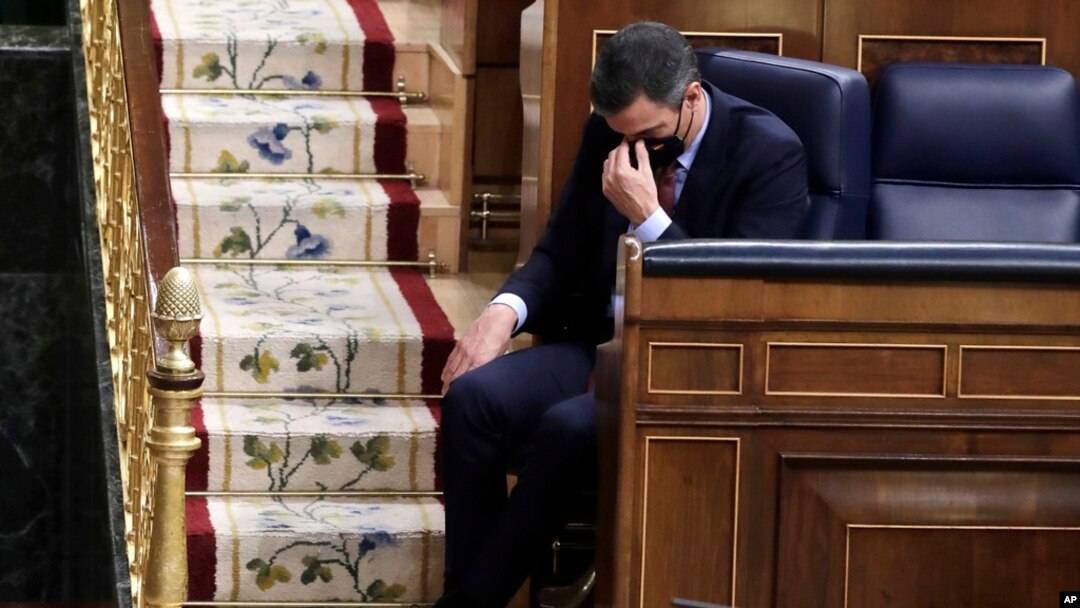 FILE - Spain's Prime Minister Pedro Sanchez listens to a speech by Vox party leader Santiago Abascal during a parliamentary session in Madrid, Spain, Oct. 21, 2020.