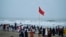 People gather at beach in Cox's Bazar on May 12, 2023, ahead of the landfall of cyclone Mocha. Myanmar and Bangladesh deployed thousands of volunteers and ordered evacuations as the Bay of Bengal's first cyclone of the year approached.