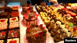 FILE - Cakes with different icing and flavors are for sale ahead of Valentine's Day in London, Britain, February 13, 2023. (REUTERS/Peter Nicholls)