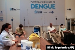 FILE - Patients suspected of having dengue fever get care at a health center in Rio de Janeiro, Brazil, Feb. 23, 2024. (AP Photo/Silvia Izquierdo)