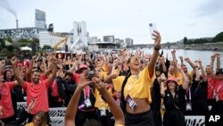 Satou Sabally of Germany takes a selfie with athletes on a boat, in Paris, ahead of the opening ceremony for the 2024 Summer Olympics, July 26, 2024.