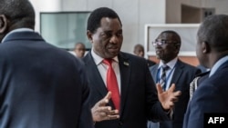 FILE - Zambian President Hakainde Hichilema, center, is pictured in Addis Ababa, Ethiopia, Feb. 19, 2023. He had said prior to recent arrests of 18 Finance Ministry officials that corruption probes "must be conducted without any interference," his Cabinet secretary said.
