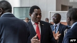 FILE - Zambian President Hakainde Hichilema, center, is pictured in Addis Ababa, Ethiopia, on Feb. 19, 2023. Zambia is now working to secure restructuring of its heavy debt load, with prime debt holder China agreeing.