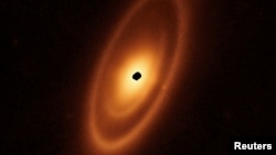 FILE - This image of the dusty debris disk surrounding the star Fomalhaut is from the James Webb Space TelescopeÕs Mid-Infrared Instrument (MIRI), (23 billion kilometers) from the star. The inner belts were revealed by Webb for the first time.
(NASA, ESA, CSA/Handout via REUTERS)