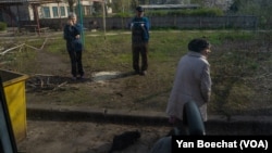 Families from Bakhmut living in a shelter say goodbye to friends who are being evacuated further from the front-line areas, in Konstiantynivka, Ukraine, April 11, 2023.