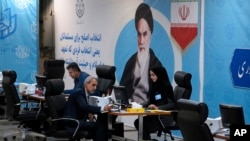 Iranian lawmaker Abbas Moghtadaiee, left, registers his name as a candidate for the June 28 presidential elections at the Interior Ministry in Tehran, Iran, May 30, 2024.