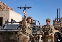 FILE - British soldiers launch a drone during exercises at Fort Irwin, Calif., Nov. 4, 2022. Taiwan, U.S. and Chinese planners are readying themselves for combat featuring air and sea drones. (Defense Visual Information Distribution Service via AP)