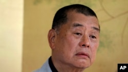 FILE - Hong Kong media tycoon Jimmy Lai pauses during an interview in Hong Kong on July 1, 2020.