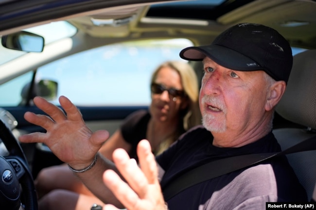 Paul Hodgson talks about the anger in the community over one homeowner's poisoning of a neighbor's trees to gain a waterfront view, Tuesday, June 4, 2024, in Camden, Maine. (AP Photo/Robert F. Bukaty)