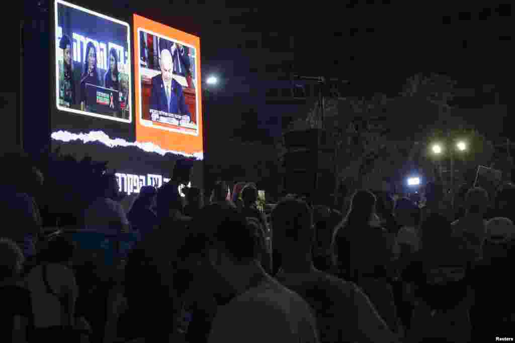 Israelis and hostage families watch a screening of Israeli Prime Minister Benjamin Netanyahu as he addresses Congress on a visit to the U.S. at the so-called "Hostages Square", in Tel Aviv, Israel, July 24, 2024.