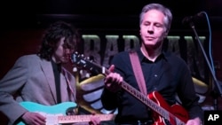 U.S. Secretary of State Antony Blinken performs "Rockin' in the Free World" with members of The 1999 band at the Barman Dictat bar in Kyiv, Ukraine. Blinken sought to rally the spirits of Ukrainians facing a severe new Russian offensive, telling them that they are not alone and that billions of dollars in American military aid is on its way to the country.