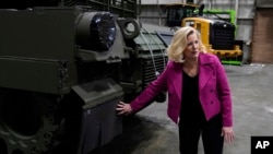 FILE - Secretary of the Army Christine Wormuth looks over the latest version of the M1A2 Abrams main battle tank as she tours the Joint Systems Manufacturing Center, Feb. 16, 2023, in Lima, Ohio.