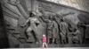 A girl walks by the Monument to the Conquerors of Space, atop the Memorial Museum of Cosmonautics, in Moscow, April 12, 2024. Russia on April 24 blocked a U.N. Security Council resolution reaffirming the need to prevent a nuclear arms race in space.