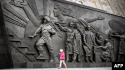 A girl walks by the Monument to the Conquerors of Space, atop the Memorial Museum of Cosmonautics, in Moscow, April 12, 2024. Russia on April 24 blocked a U.N. Security Council resolution reaffirming the need to prevent a nuclear arms race in space.