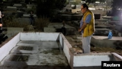 Izzeldin Abuelaish, a Palestinian doctor, visits the graves of his three daughters who were killed during the 2009 war in Gaza, at a cemetery in northern Gaza Strip, Nov. 15, 2021.