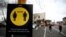 FILE - People jog past a social distancing and mask-wearing sign, in Auckland, New Zealand, Aug. 31, 2020. New Zealand announced on Aug. 14, 2023, that it was removing the last of its remaining COVID-19 restrictions.