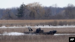 A police boat searches in Akwesasne, Quebec, March 31, 2023.