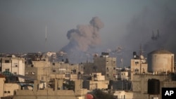 Smoke rises from town of Khan Younis after Israeli strikes on Dec. 15, 2023.