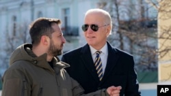 President Joe Biden, right, and Ukrainian President Volodymyr Zelenskyy talk during an unannounced visit in Kyiv, Ukraine, Feb. 20, 2023. (Ukrainian Presidential Press Office via AP)