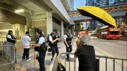 香港社運人士王婆婆4月24日傍晚在高等法院囚車出入口外，撐黃傘及高呼口號，聲援被還柙的支聯會國安案3名被告李卓人、何俊仁及鄒幸彤。(美國之音)