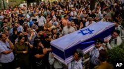 Israeli soldiers carry the flag-covered coffin of Shilo Rauchberger at the Mount Herzl cemetery in Jerusalem, Oct. 12, 2023.
