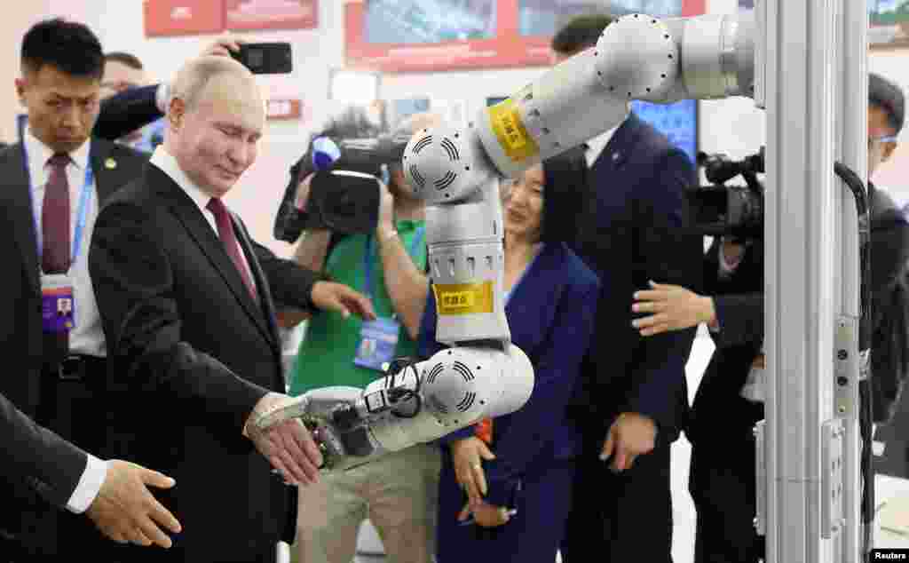 Russian President Vladimir Putin tours a show at the 8th Russian-Chinese EXPO in Harbin, China. (Sputnik/Mikhail Metzel/Pool via Reuters)