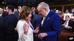 FILE - Then-House Speaker Nancy Pelosi, left, and Senate Majority Leader Chuck Schumer speak before President Joe Biden delivers the State of the Union address to a joint session of Congress at the Capitol, March 7, 2024, in Washington. 