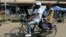 A family cycles in Harare on June 1, 2024. 