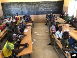 FILE- Children gather in a classroom at school in the village of Dori, Burkina Faso, Oct. 20, 2020.