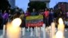 A person holds Venezuela's national flag with the writing "Venezuela, free and democratic" during a vigil in tribute to citizens who were detained following disputed election results, in Caracas, Venezuela, Aug. 8, 2024.