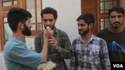 Supporters of the Awami Itihad Party feed sweets to Abrar Rashid, son of the imprisoned Sheikh Abdul Rashid. 'Engineer Rashid' defeated over 20 candidates from the Baramulla parliamentary constituency on the Indian side of Kashmir. (Wasim Nabi for VOA)