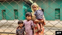 A Rohingya family arrives for a meeting with the Myanmar officials in Teknaf, Bangladesh, March 15, 2023. 