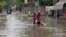 Motorcyclists ride through a flooded street after a heavy rainfall in Lahore, Pakistan, July 1, 2024.