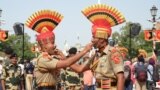 Indian Border Security Force (BSF) personnel offers sweets to each other on the occasion of the countrys 77th Independence Day celebrations at India-Pakistan Wagah Border post, some 35 km from Amritsar, Aug. 15, 2023.