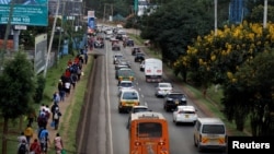 FILE - Cars and pedestrians line the road in Nairobi, Kenya, March 27, 2020.