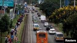 FILE - Cars and pedestrians line the road in Nairobi, Kenya, March 27, 2020. Road deaths have increased in Africa in the past decade, due to poor safety standards and lack of enforcement of safety laws.
