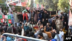 Supporters of former Pakistani Prime Minister Imran Khan chant slogans outside his house in Lahore, March 5, 2023.