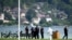 FILE - Security forces examine the scene of knife attack in Annecy, French Alps, June 8, 2023. 