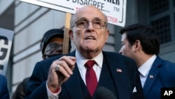 FILE - Rudy Giuliani speaks outside the federal courthouse in Washington, Dec. 15, 2023. Giuliani, a former Donald Trump attorney, was processed June 10, 2024, in the criminal case over the effort to overturn Trump’s Arizona election loss to Joe Biden.