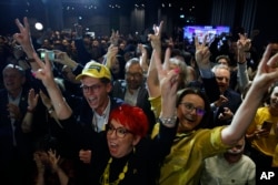 Supporters of the coalition of the centrist Poland 2050 party and the agrarian Polish People's Party celebrate their victory at election headquarters in Warsaw, Poland, Sunday, October 15, 2023. (AP/Michal Dyjuk)