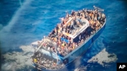 FILE - This undated handout image provided by Greece's coast guard on Wednesday, June 14, 2023, shows scores of people on a battered fishing boat, the Adriana, that later capsized and sank off southern Greece.