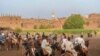 Dozens of performers assemble on a plot of farmland for the El-Mermah competition. The objective is to tap competitors with a long stick from the back of a galloping horse. In the village of Al-Biirat, Egypt on Sept. 12, 2023. (Hamada Elrasam/VOA)