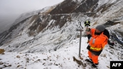 A worker installs surveying equipment in Denali National Park, Alaska, on September 21, 2022. 