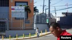 People walk past the Taiwan Embassy after Honduras has given Taiwan 30 days to vacate its embassy after severing relations with Taiwan in favor of China, in Tegucigalpa, Honduras, March 26, 2023.