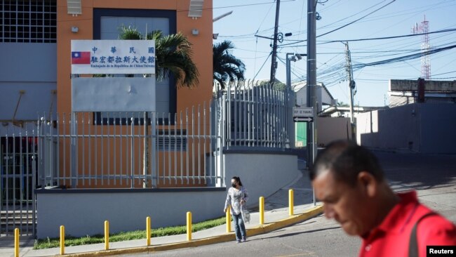 People walk past the Taiwan Embassy after Honduras has given Taiwan 30 days to vacate its embassy after severing relations with Taiwan in favor of China, in Tegucigalpa, Honduras, March 26, 2023.