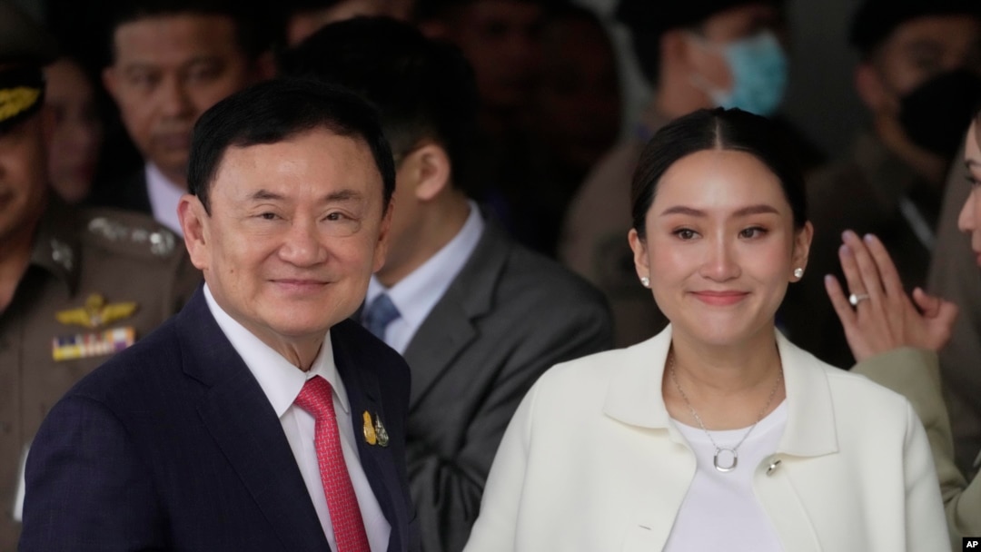 FILE - Thailand's former Prime Minister Thaksin Shinawatra, with his daughter Paetongtarn, arrives at Don Muang airport in Bangkok, Aug. 22, 2023. Paetongtarn Shinawatra. On Sunday she formally became Thailand's 31st prime minister.