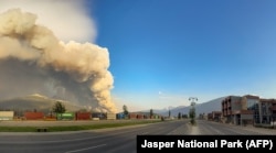 In this July 24, 2024, image obtained from the Jasper National Park in Canada, smoke rises from a wildfire burning in the park. (Handout/Jasper National Park/AFP)