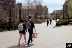 FILE - Students walk on the campus of Boston College, Monday, April 29, 2024, in Boston. (AP Photo/Charles Krupa, File)