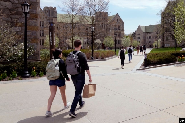 FILE - Students walk on the campus of Boston College, Monday, April 29, 2024, in Boston. (AP Photo/Charles Krupa, File)