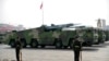 FILE - Chinese military vehicles carrying DF-17 ballistic missiles roll during a parade to commemorate the 70th anniversary of the founding of Communist China in Beijing, on Oct. 1, 2019.